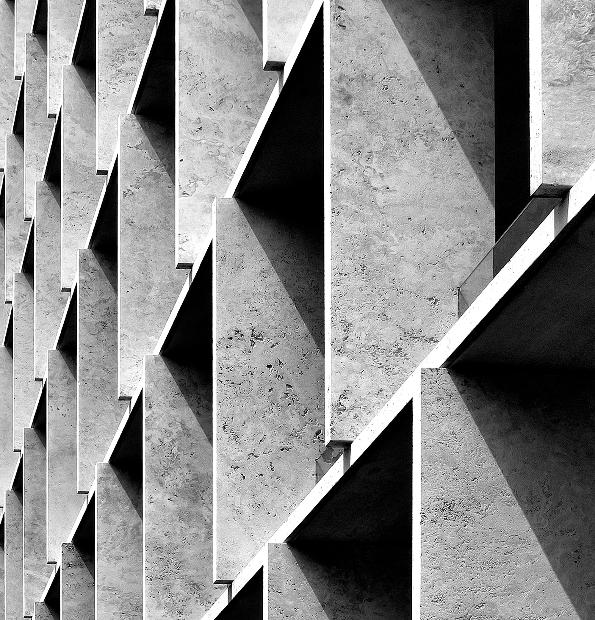 Ribbed precast concrete screen throwing triangular shadows