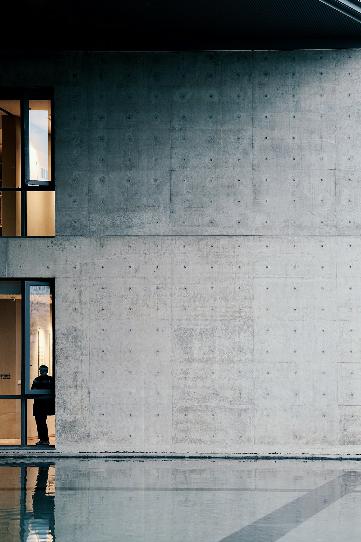 Perforated steel screen against a concrete wall
