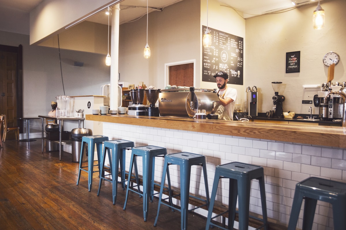The espresso bar at Harbour & Oak with a barista at the machine