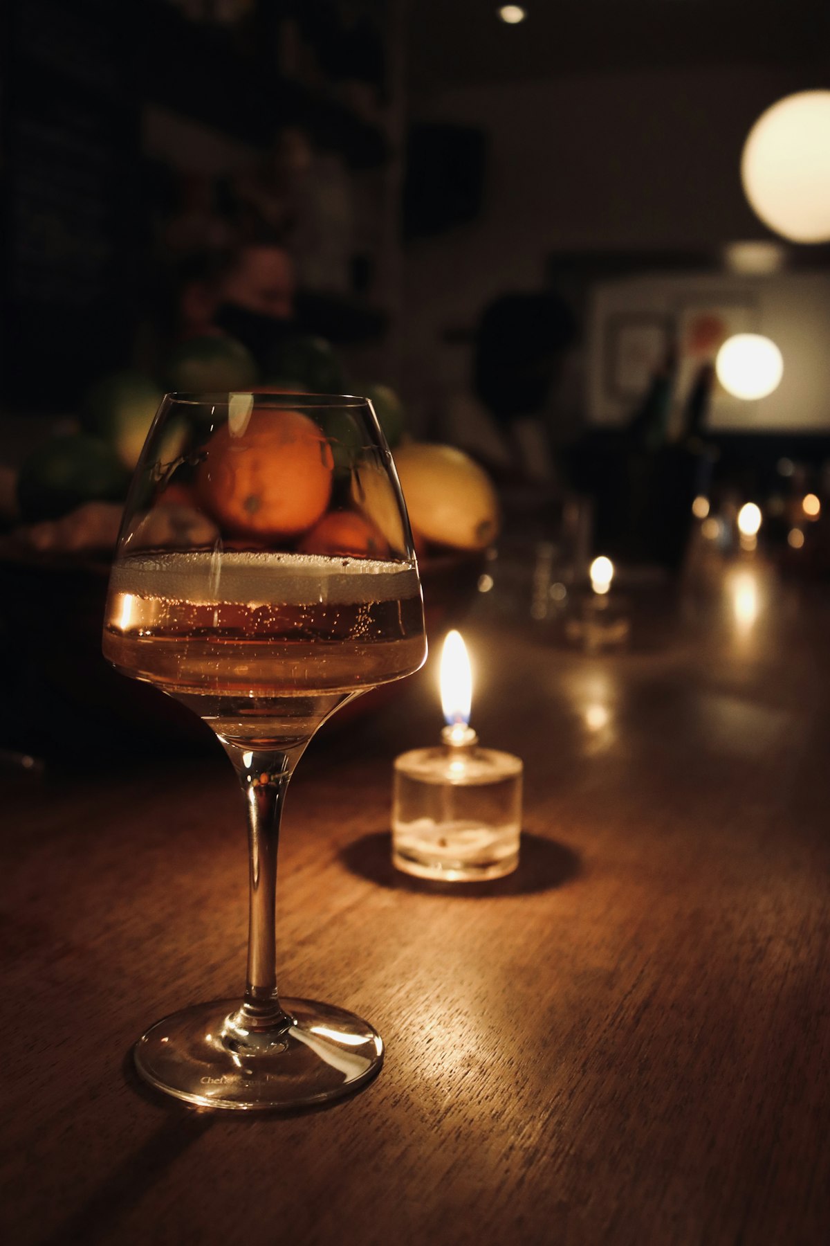 A glass by candlelight at the counter
