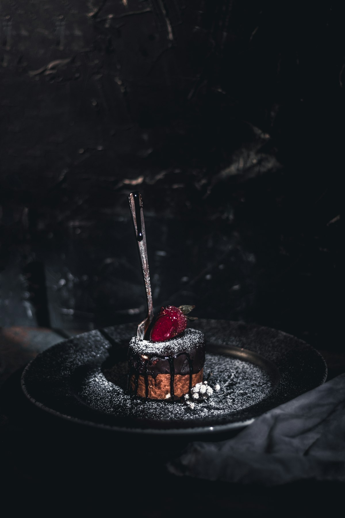 Dark chocolate delice on a black plate